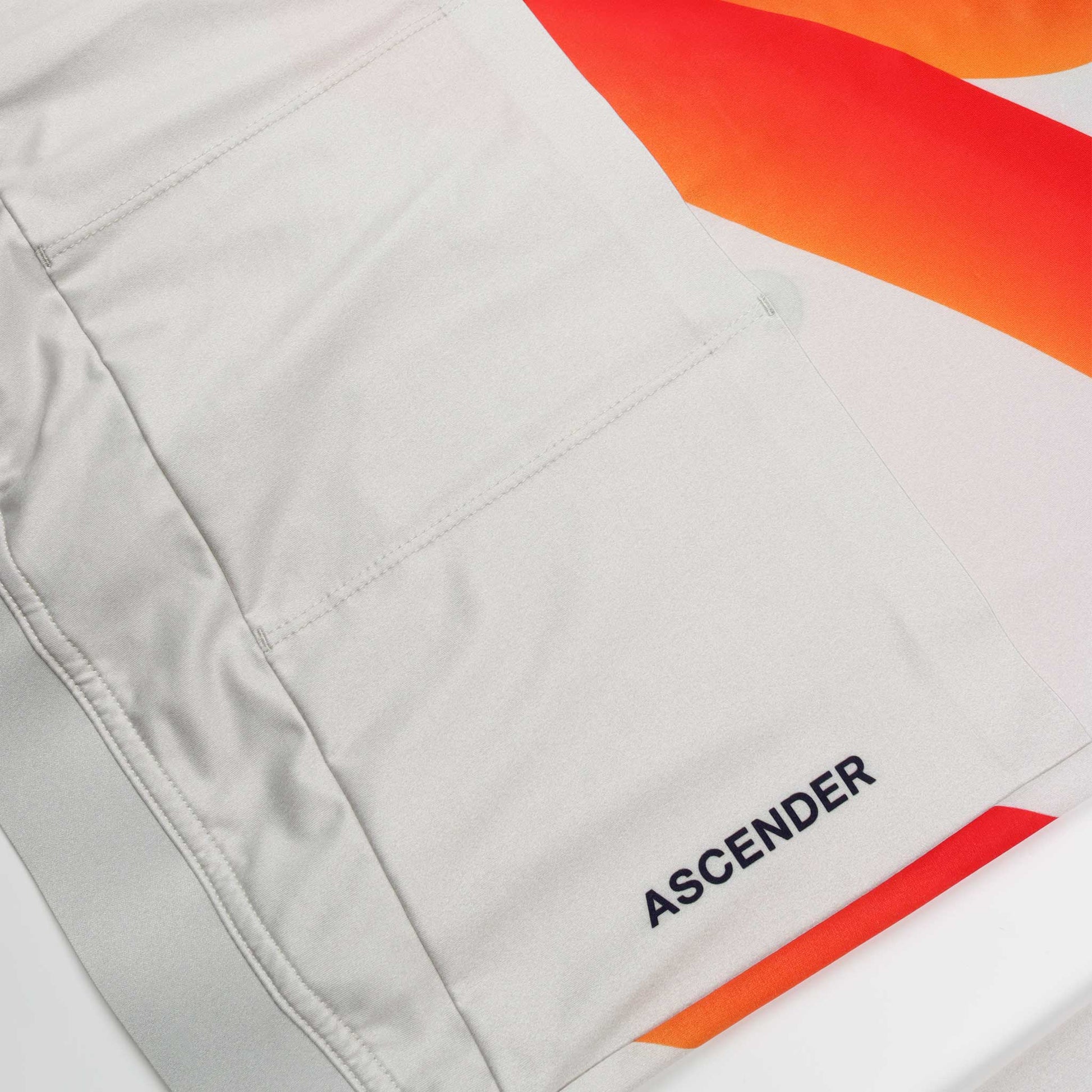 ACC Pulse LS long sleeve cycling jersey in Clouds Dancer and Orange-Red Swoosh, Back pockets view and branding ascender