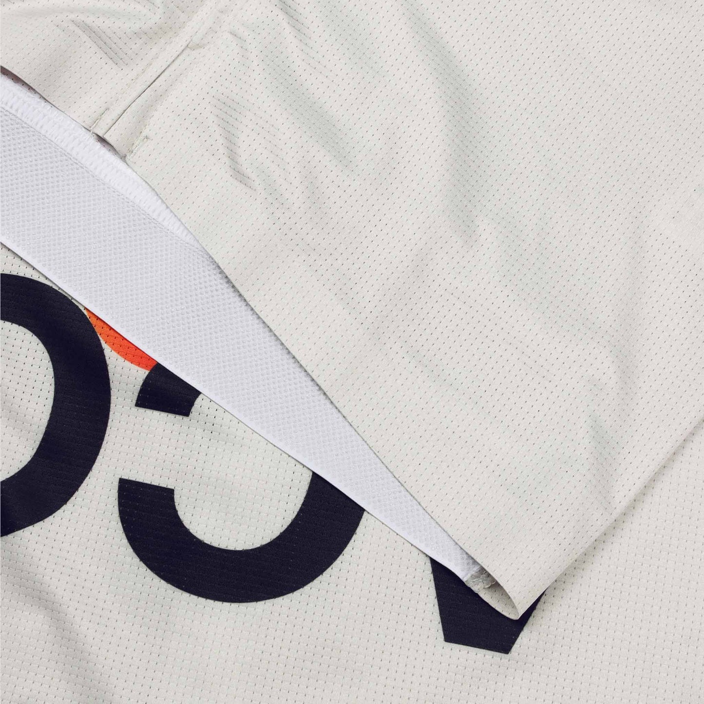 ACC Pulse short sleeve cycling jersey in Clouds Dancer with orange-red swoosh, front finishing thermo binding close-up view