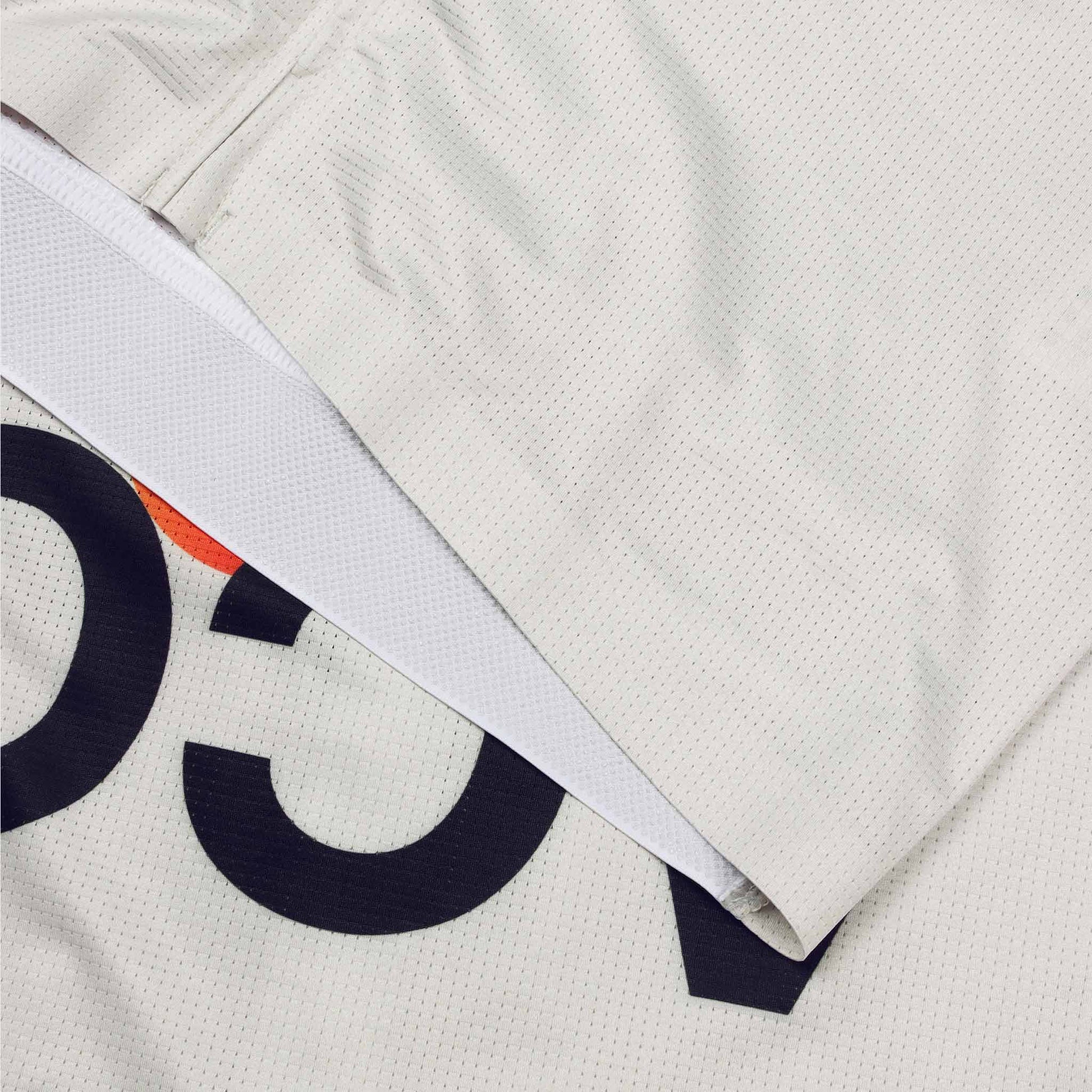 ACC Pulse short sleeve cycling jersey in Clouds Dancer with orange-red swoosh, front finishing thermo binding close-up view