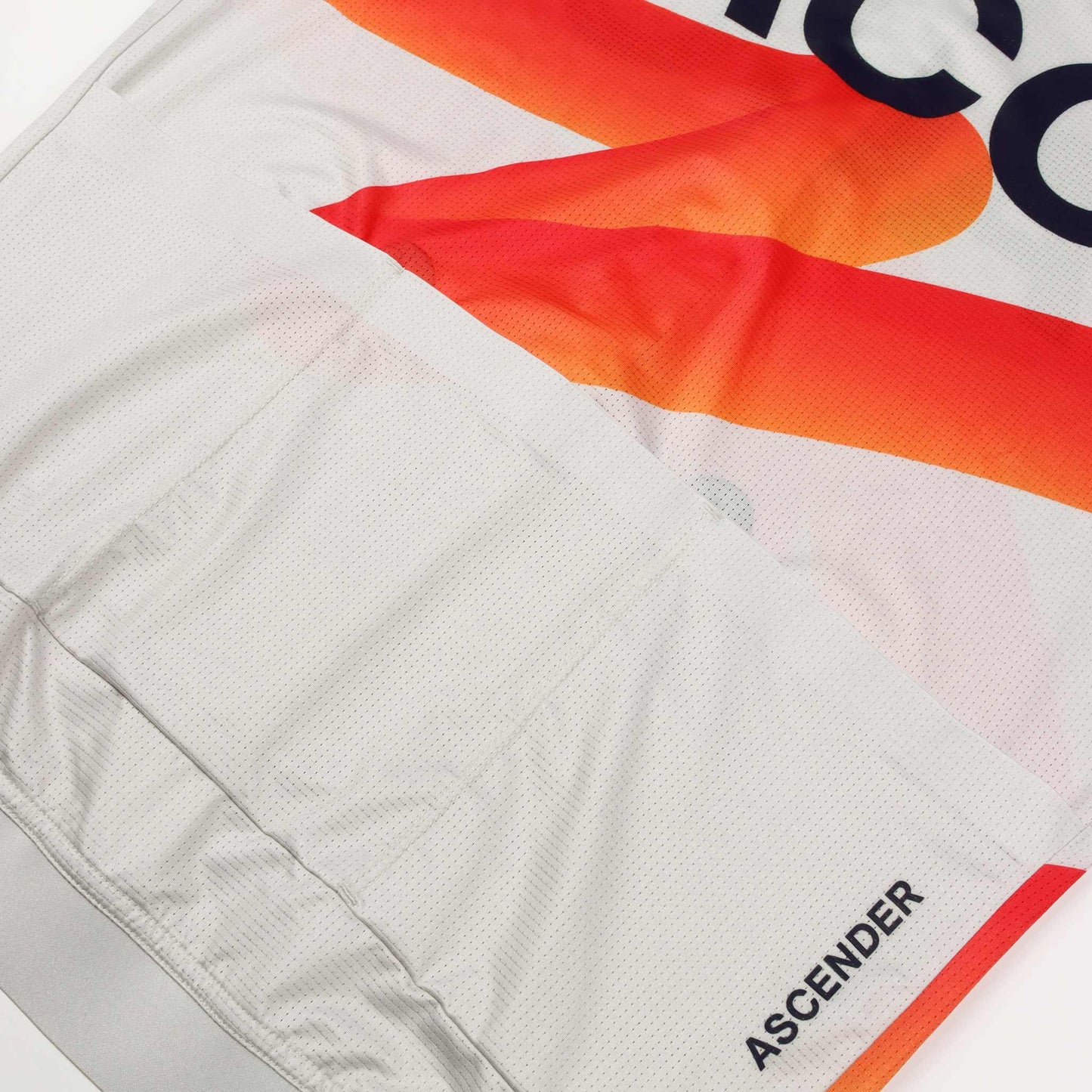 ACC Pulse short sleeve cycling jersey in Clouds Dancer with orange-red swoosh, back pockets close-up view