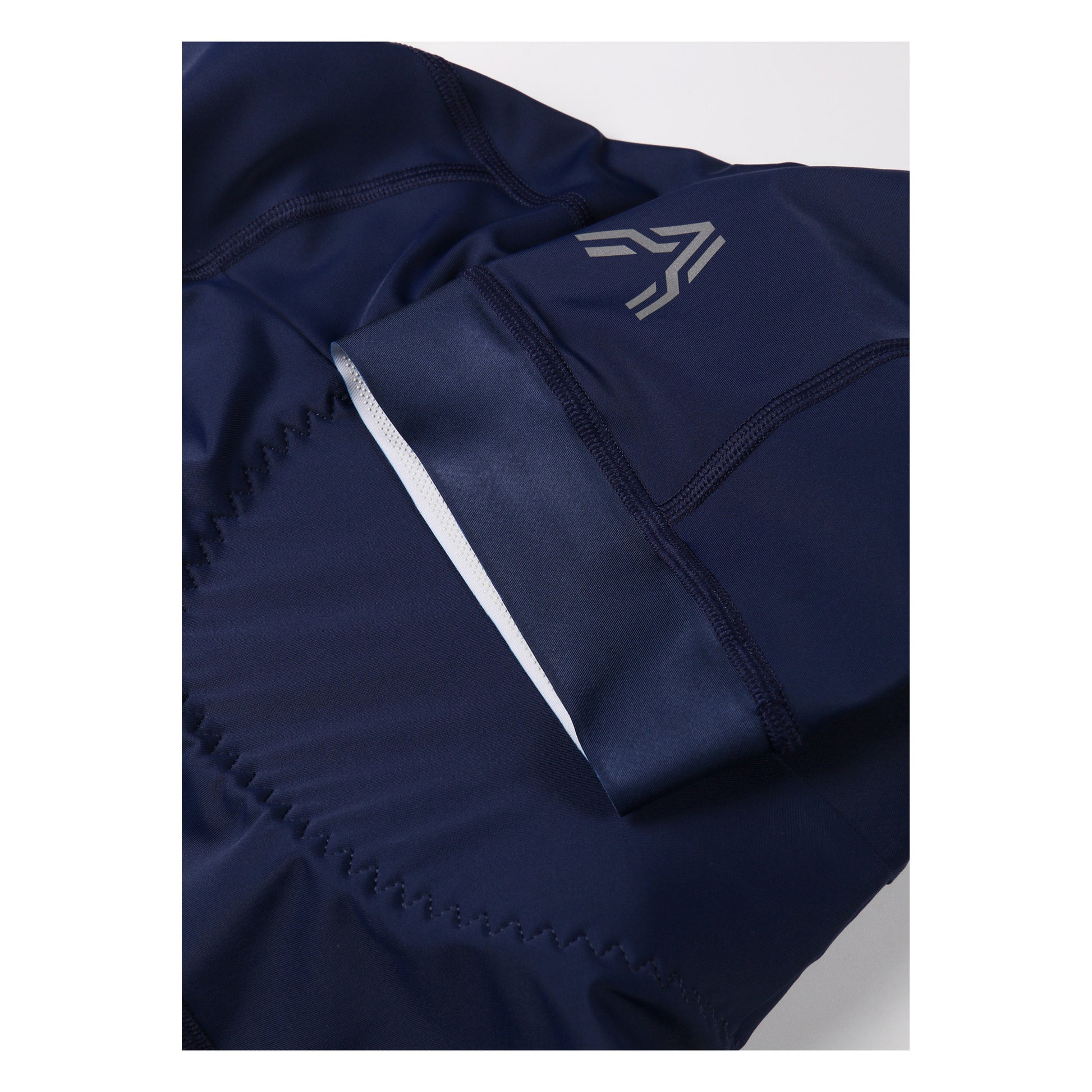Epona Women Bib Short Navy by Ascender Cycling Club Zürich in Switzerland Front Left with Reflective Logos Ascender Monogram in Detailled View and Silicone Injected Grippers